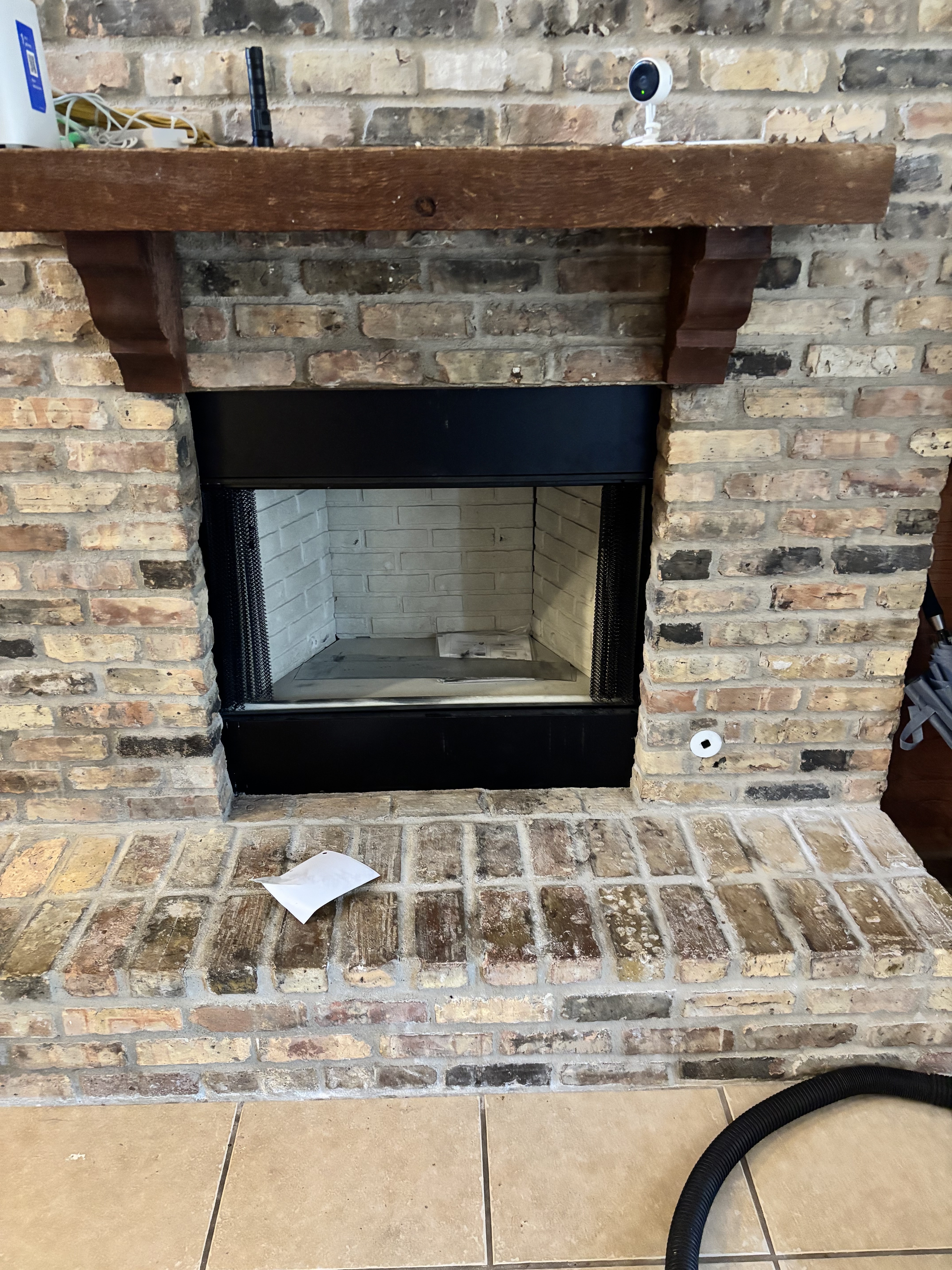 Finished firebox installed within the existing brick fireplace opening.