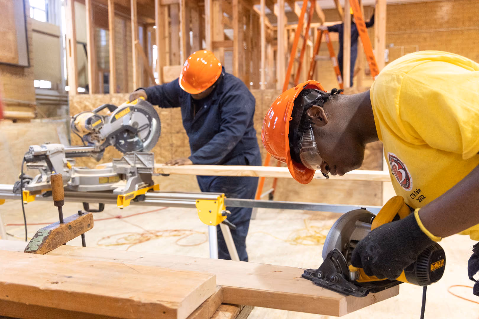 Students using power saws during carpentry construction trade class