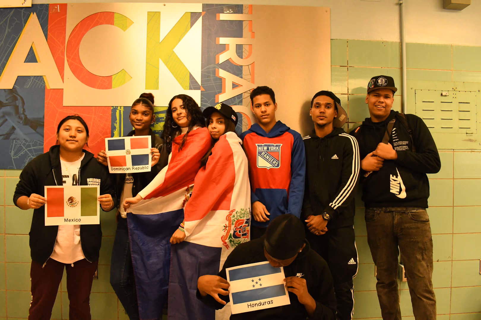 Students displaying flags of Mexico Dominican Republic and Honduras