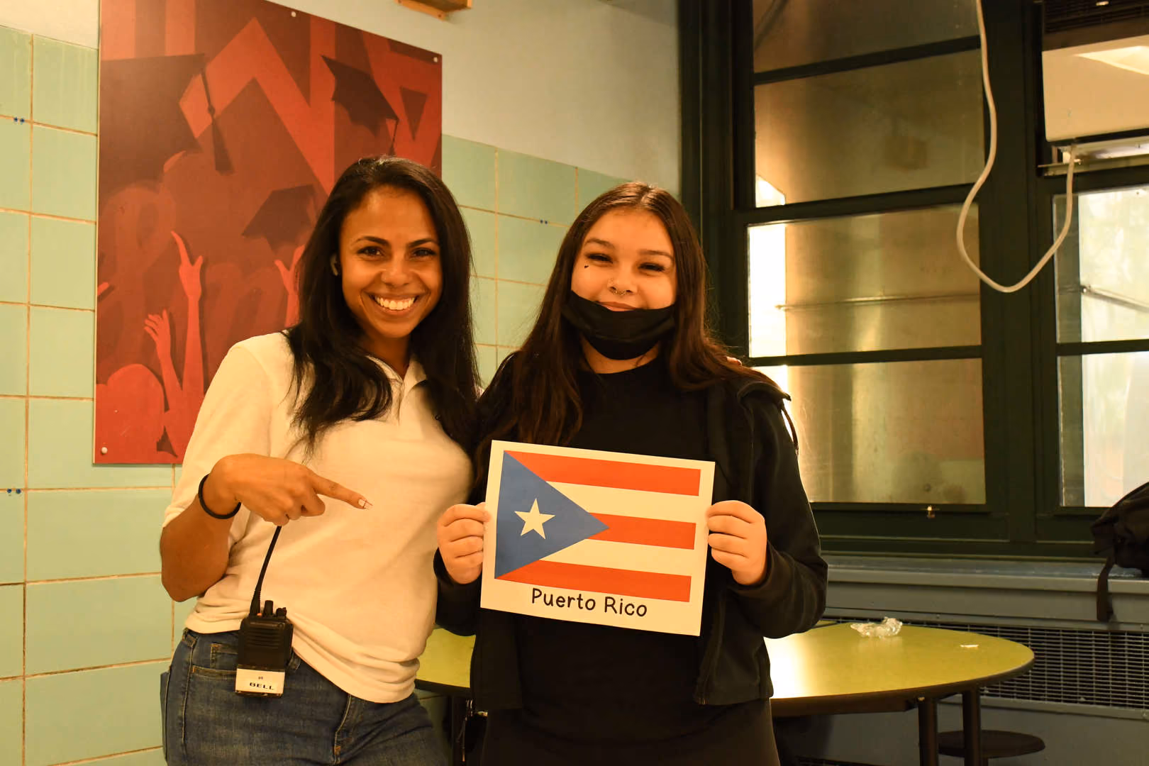 Student and staff member proudly displaying a Puerto Rico flag sign