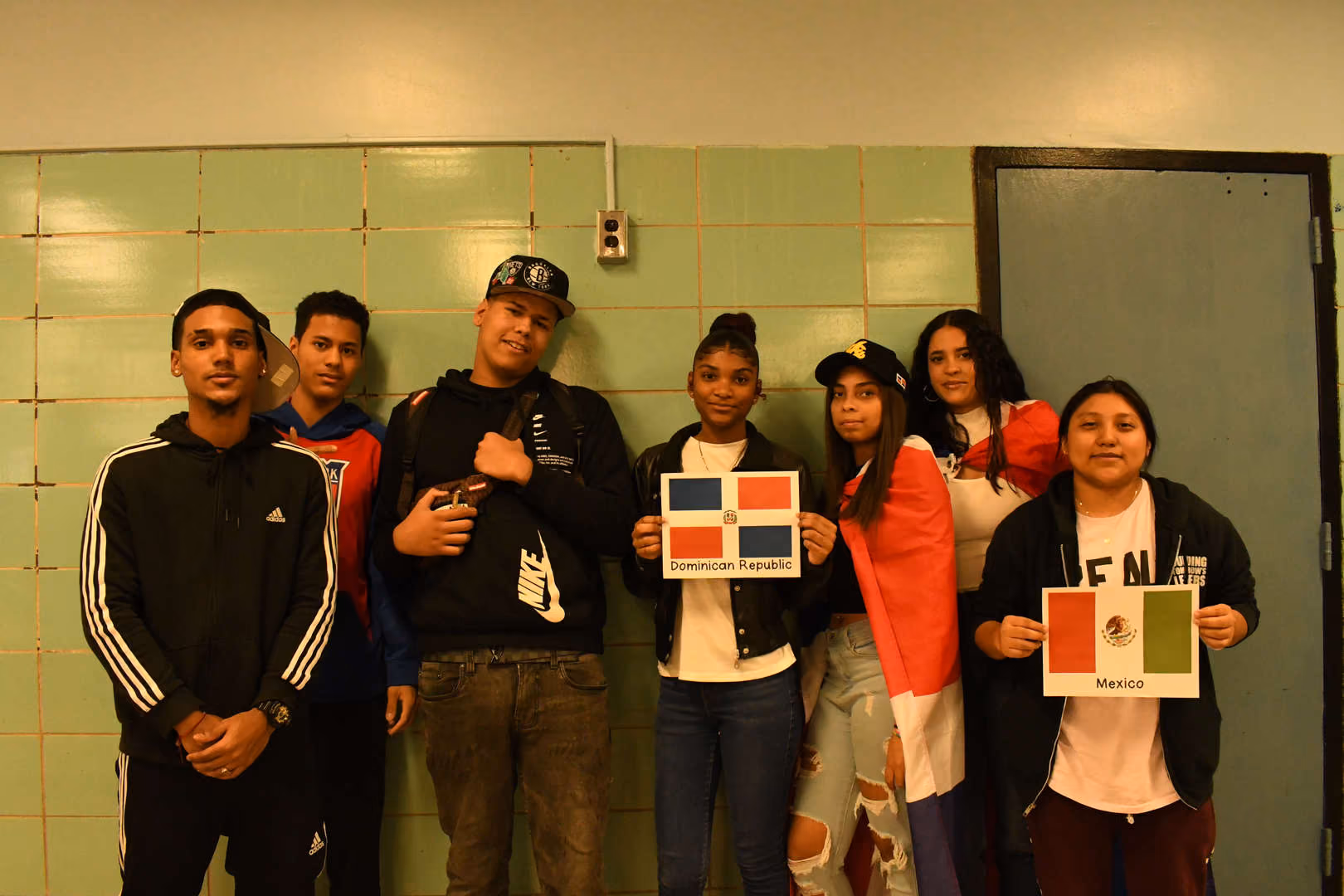 Students holding Dominican Republic and Mexico flags for Hispanic Heritage Month