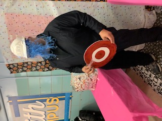 Student holding a sign at school silly string fundraiser event