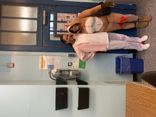Two students in pajamas posing together on Pajama Day