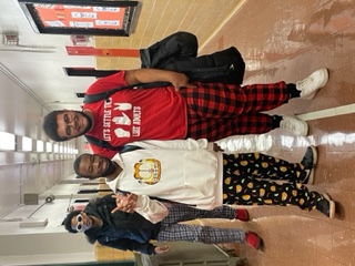 Three students posing together during school pajama day
