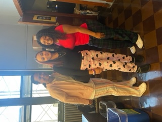 Three students posing together during school Pajama Day