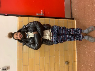 Student posing in pajamas and jacket during Pajama Day