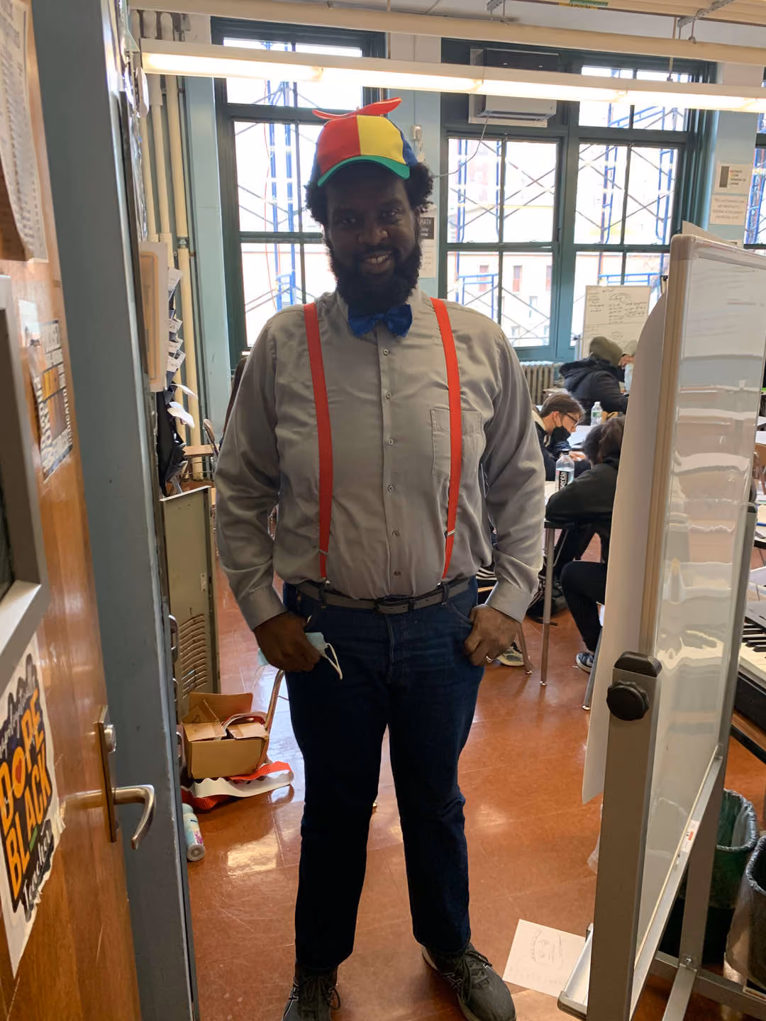 Teacher wearing colorful hat suspenders and bow tie on Nerd Day