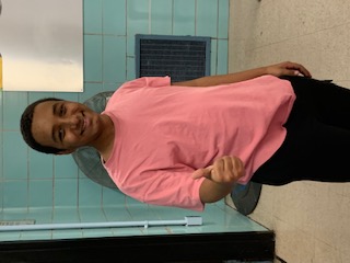 Student wearing pink shirt for Breast Cancer Awareness Month