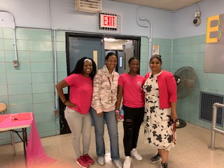 Four staff members wearing pink for Breast Cancer Awareness Month