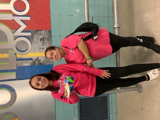 Two students wearing pink for Breast Cancer Awareness Day