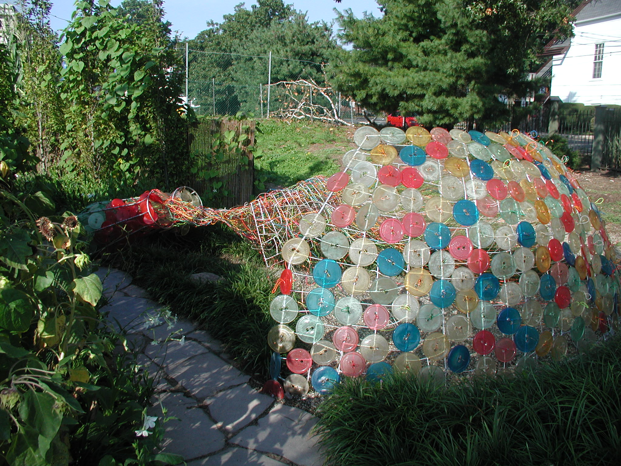 Dome-shaped wire sculpture covered in colorful translucent discs.