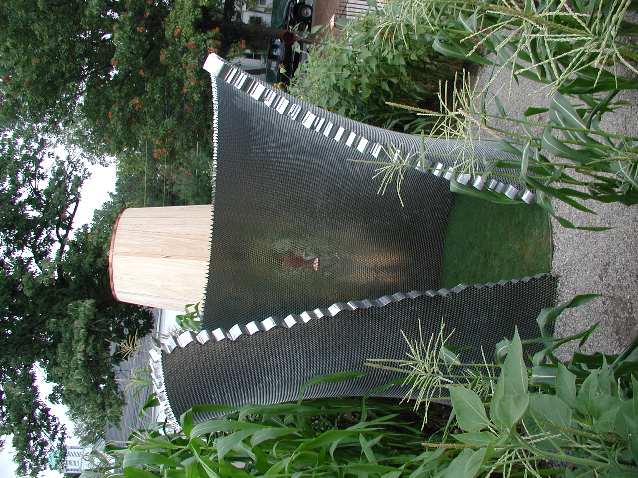 Gravel pathway beneath a pergola hung with clear glass spheres.
