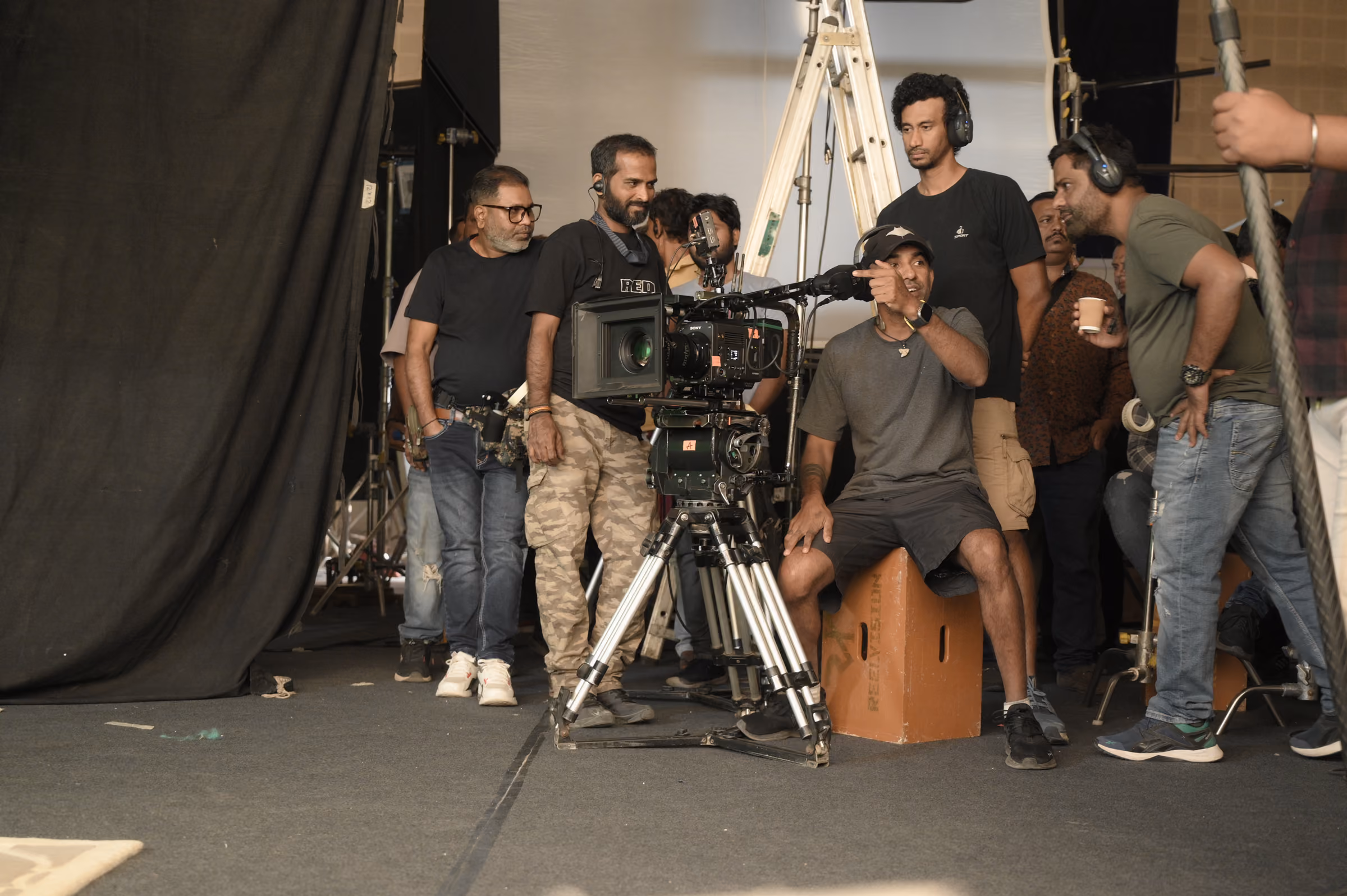 Camera crew setting up a shot on a covered outdoor set
