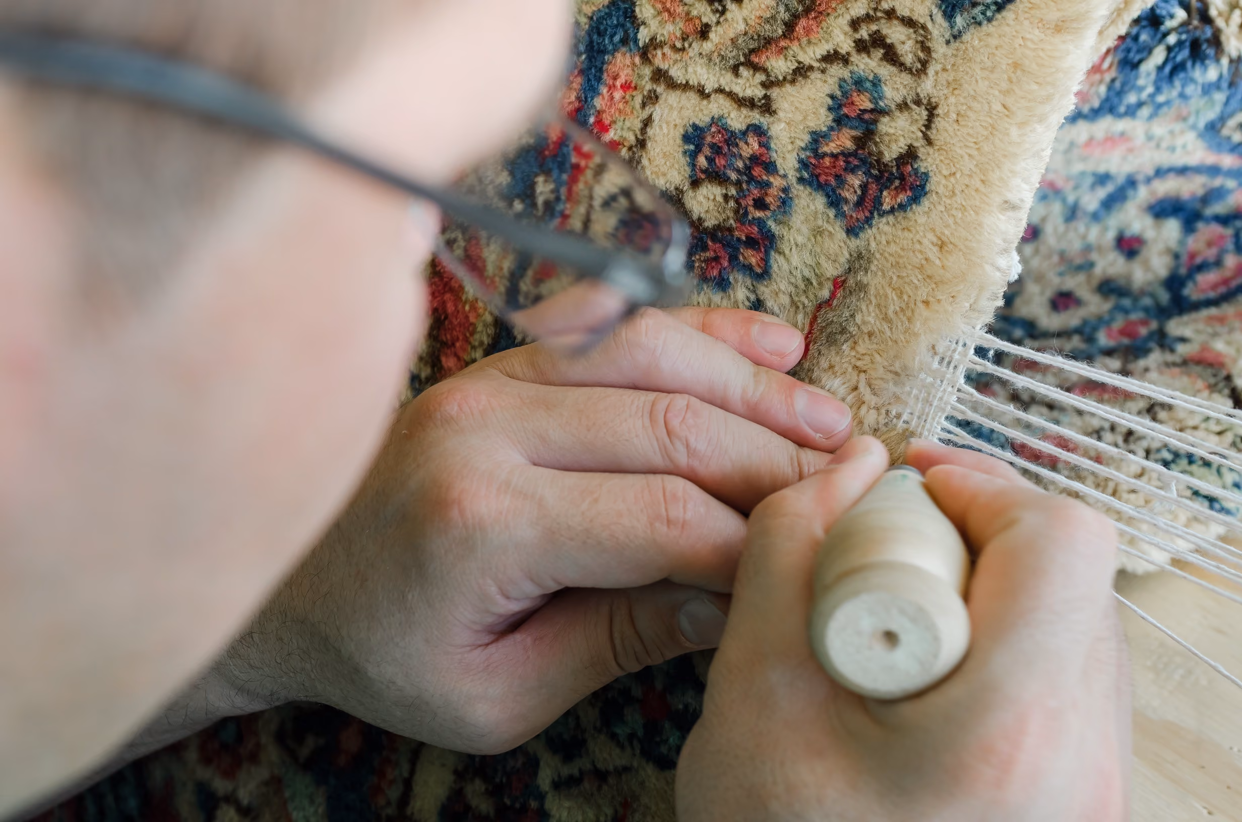 fringes being examined by an artisan