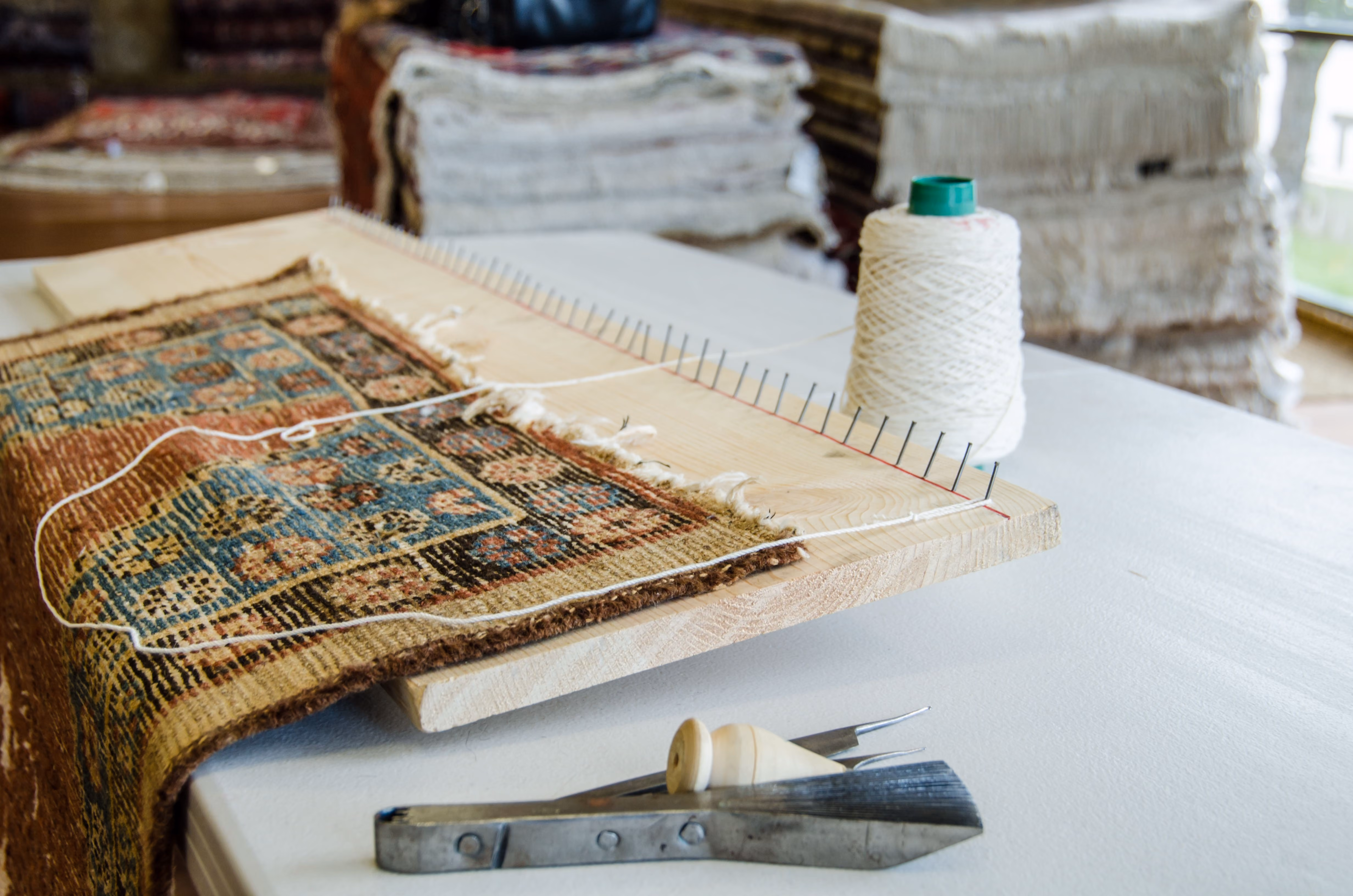 antique rug being repaired by rug refinery