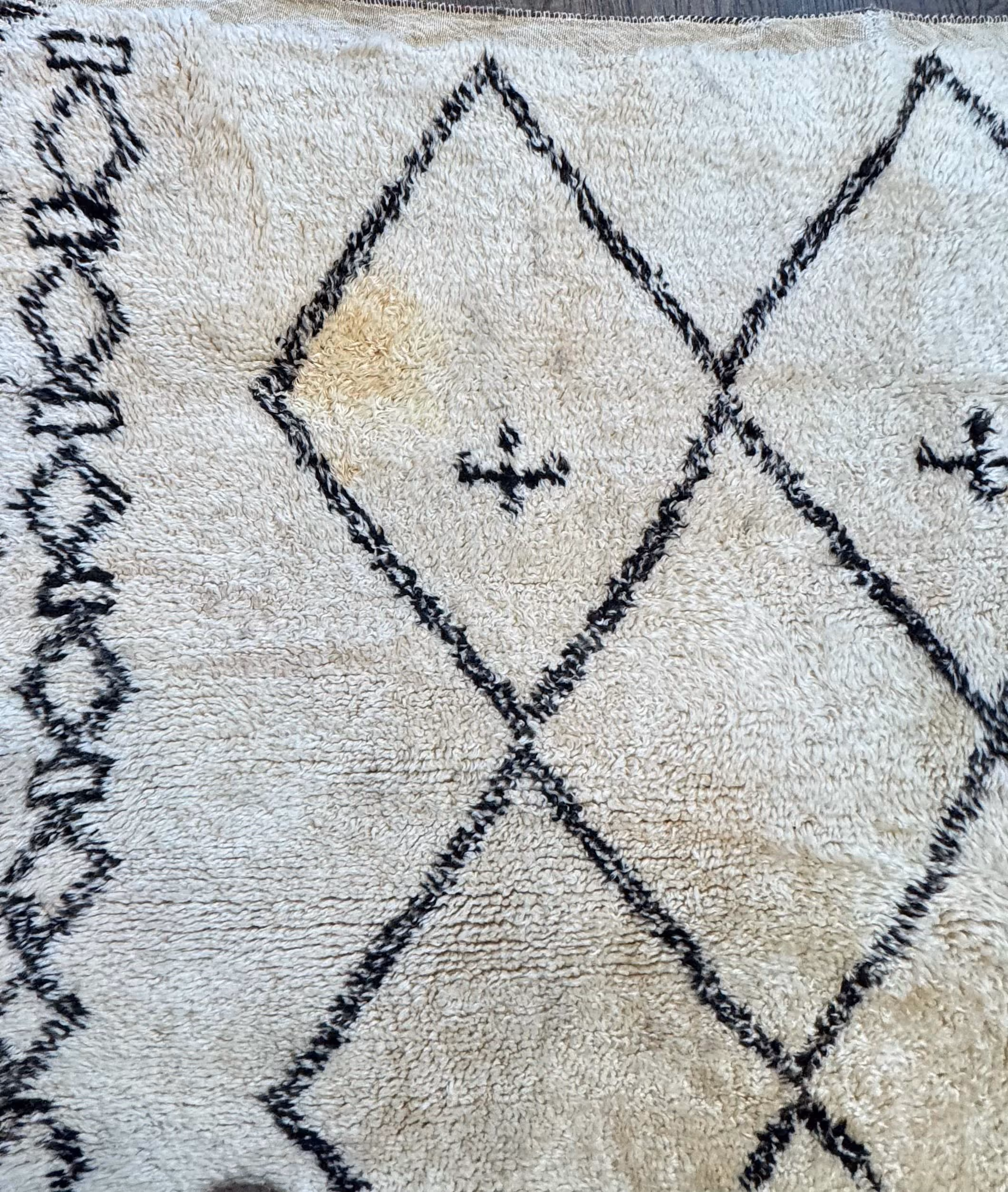 The rug before Rug Refinery's service, showing its original condition