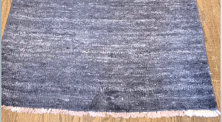 The rug before Rug Refinery's service, showing its original condition
