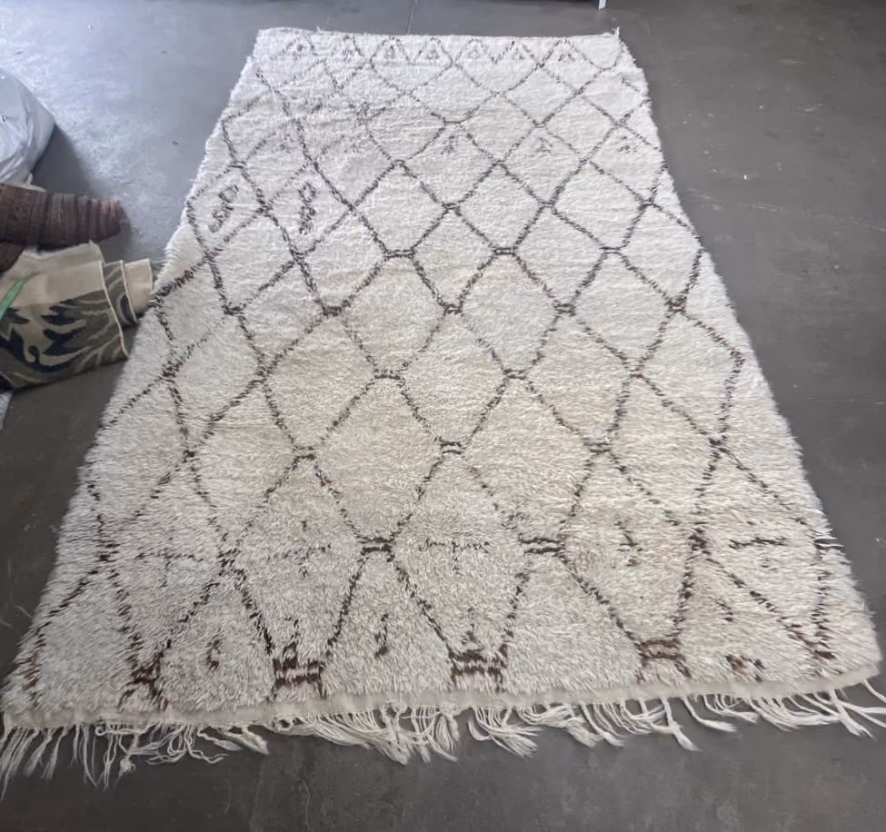 The rug before Rug Refinery's service, showing its original condition