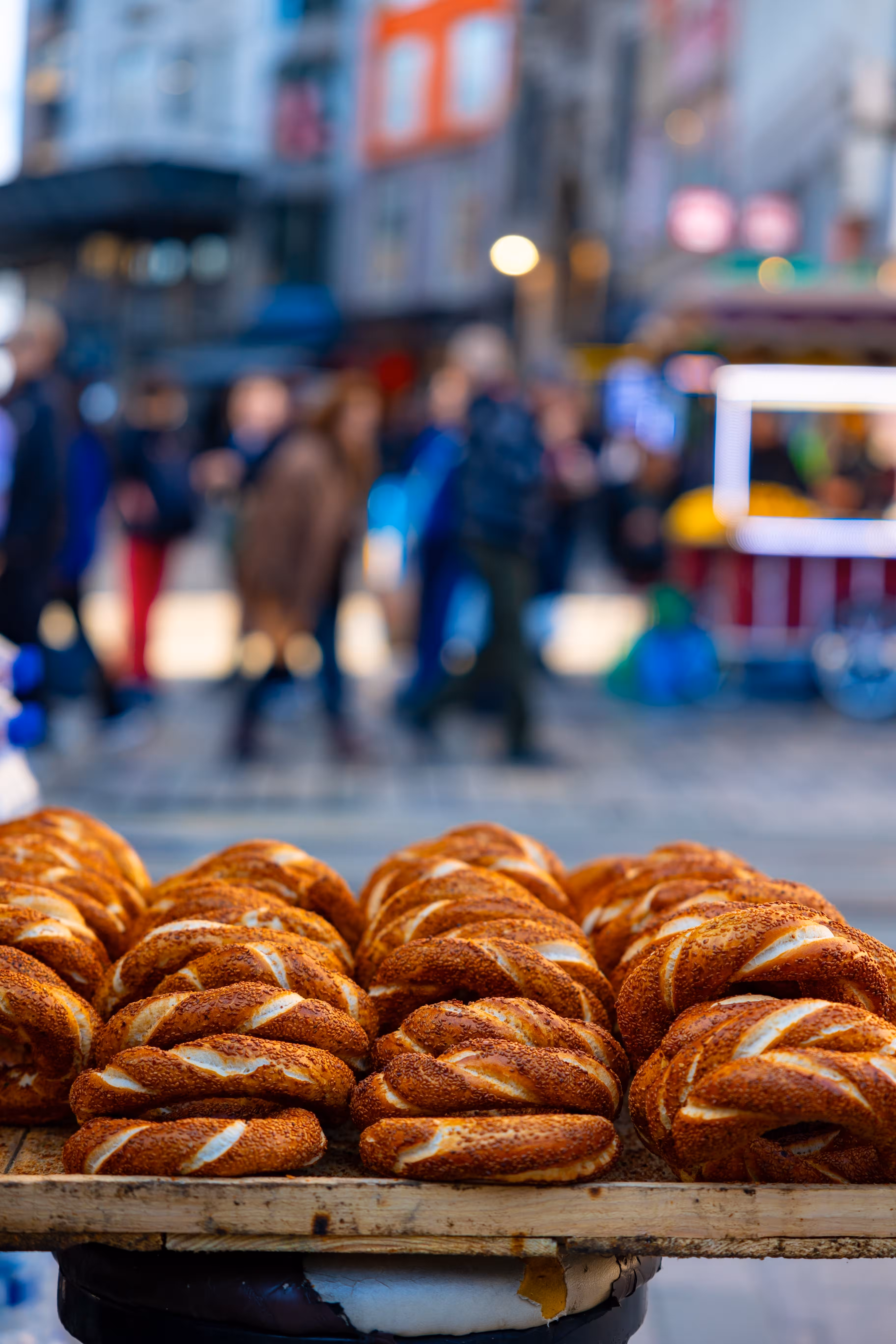 Simit sesame bread rings stacked on a street vendor's cart in Istanbul