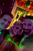 Three Marveltour colleagues taking a selfie at a party under coloured lights
