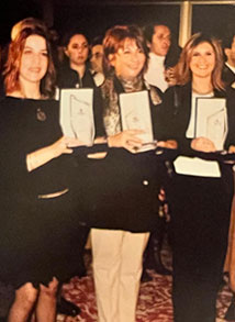 Marveltour team members holding award certificates at a ceremony