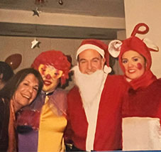 Marveltour colleagues in Santa Claus and clown costumes at an office party