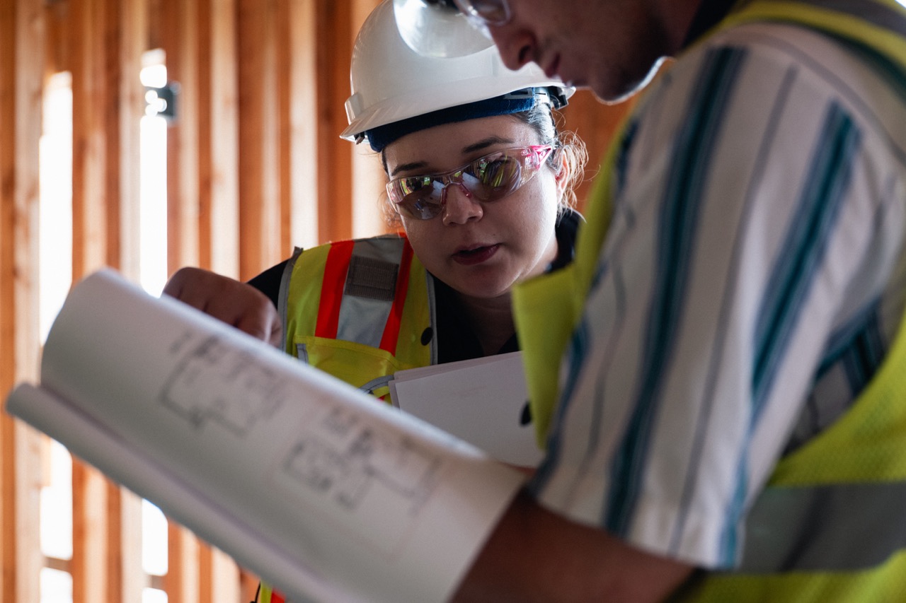 Construction team in hard hats and high-visibility vests.