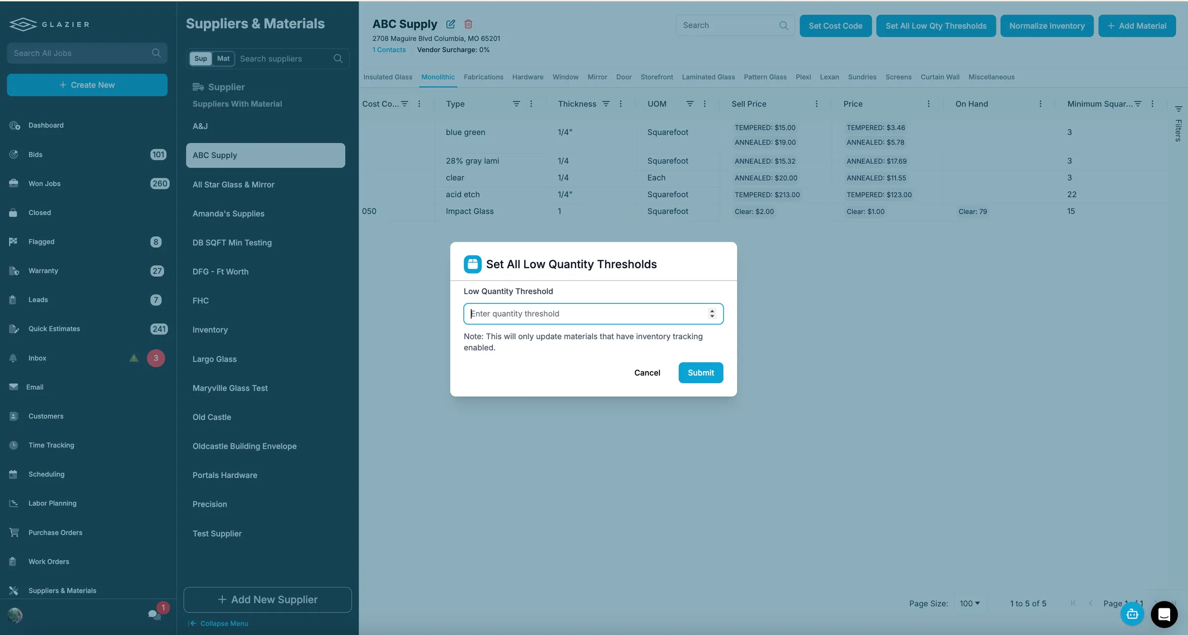 Glazier Suppliers and Materials screen with a Set All Low Quantity Thresholds dialog open over a material list that includes an On Hand column