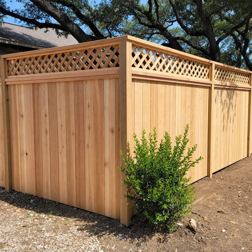 Cedar privacy fence with decorative diamond lattice top and cap rail in a Houston, TX backyard