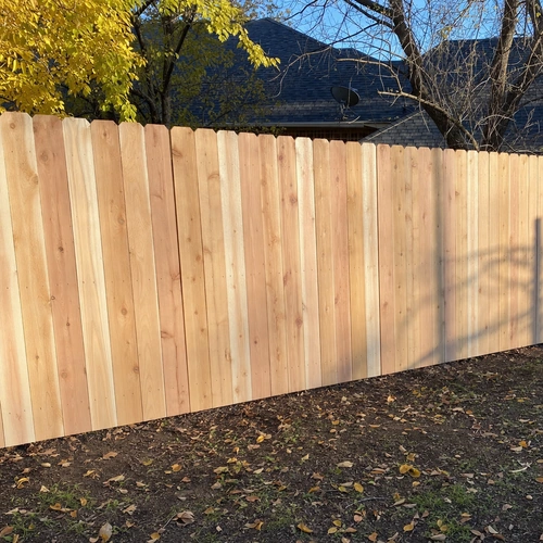 New dog-ear cedar picket privacy fence with natural wood grain in Houston, TX