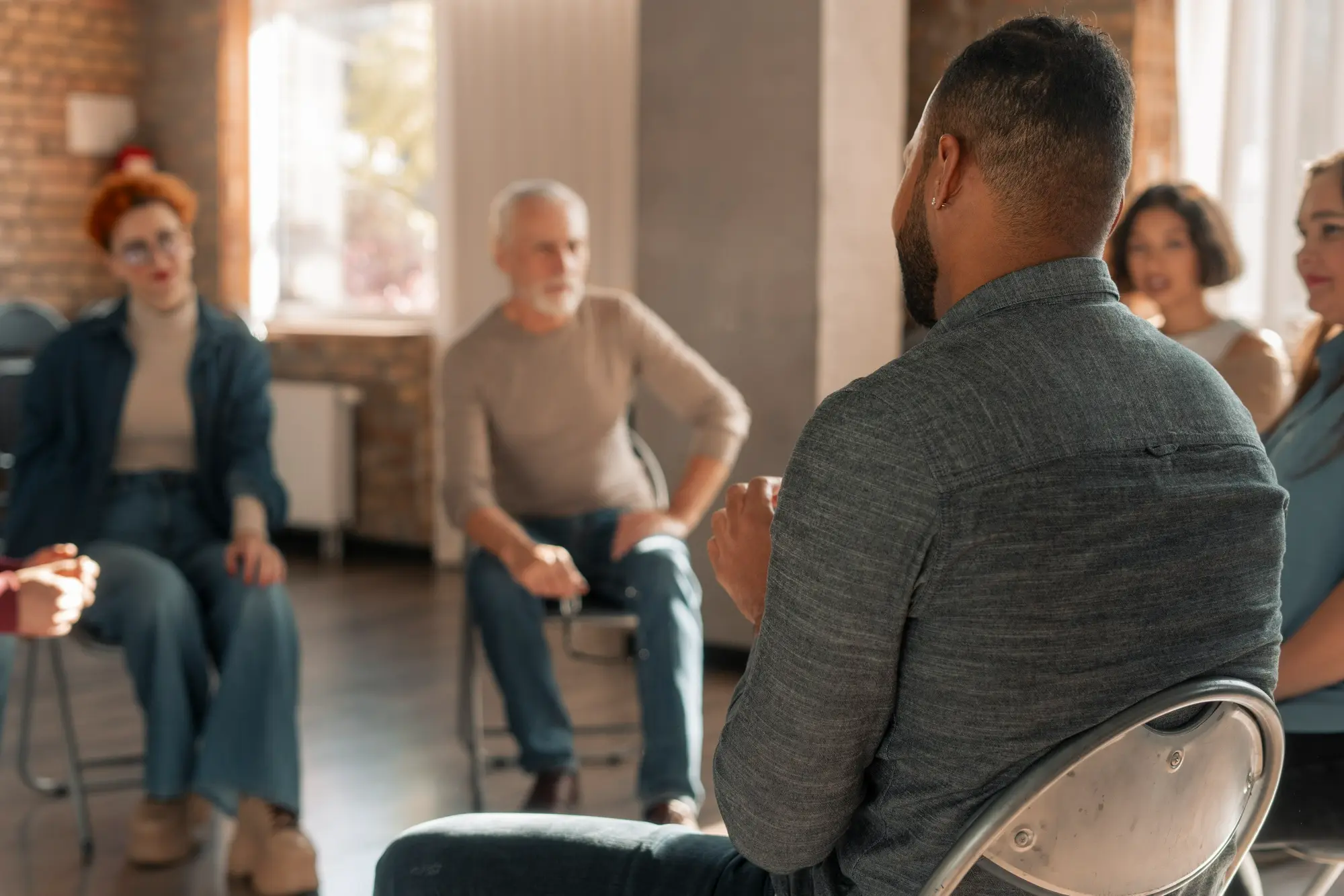 Adults participating in an outpatient alcohol addiction recovery group, sharing experiences and building peer support
