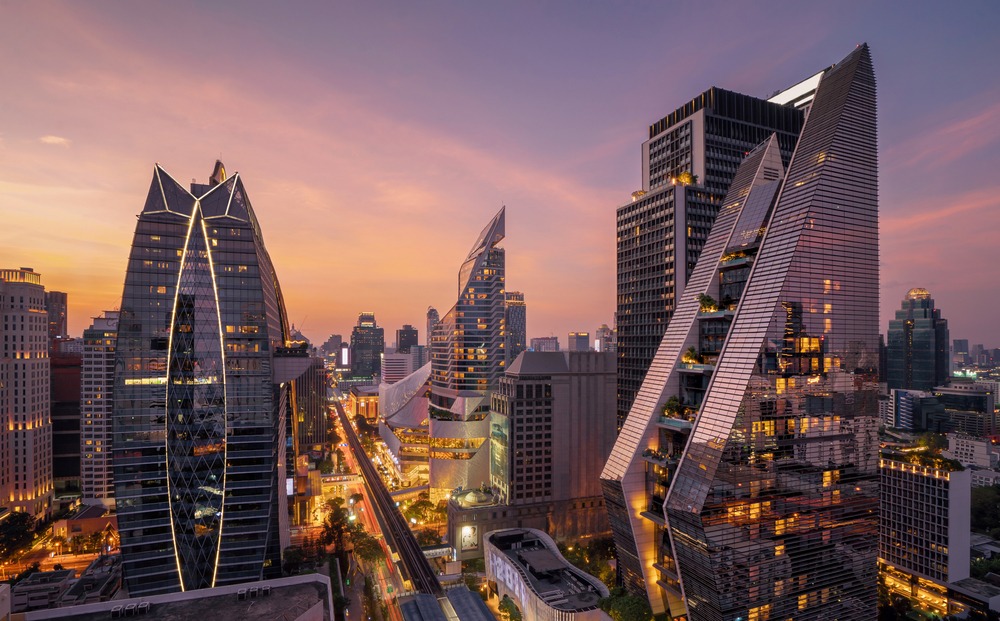 The curved twin towers of Central Embassy on Phloenchit Road at sunset
