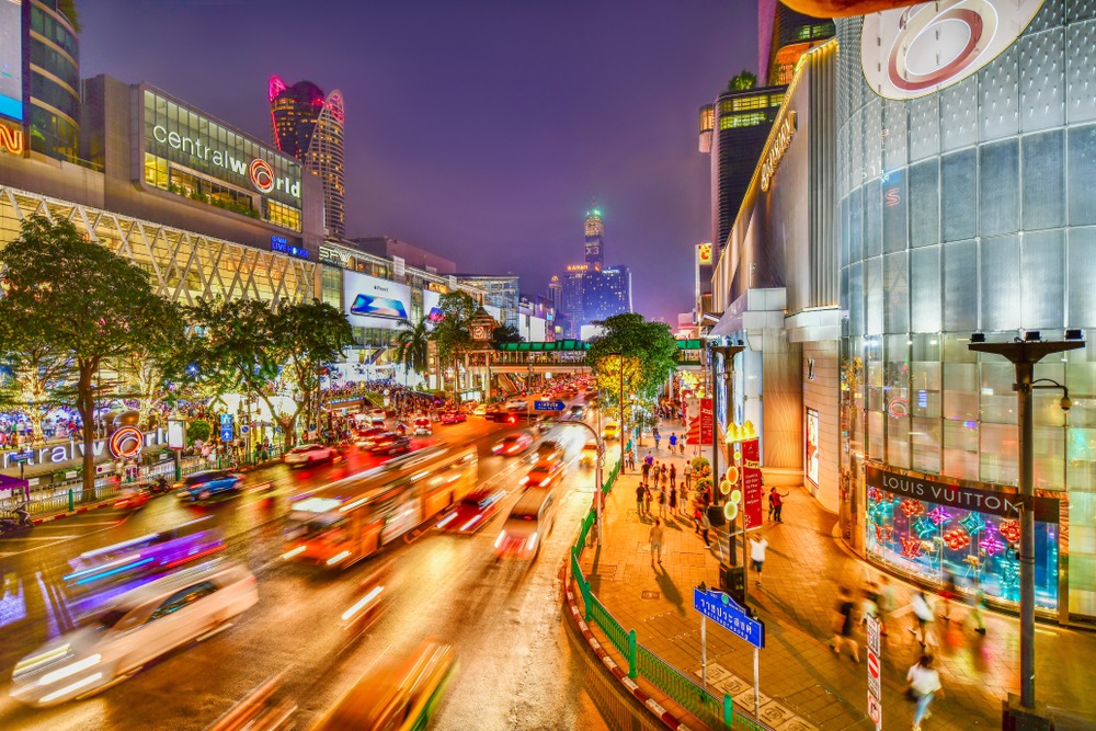 CentralWorld on Rajdamri Road at night, with light trails from passing traffic