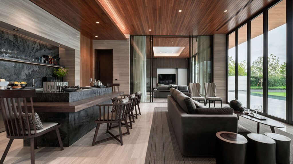 A Santiburi Residences kitchen and bar counter under a timber ceiling