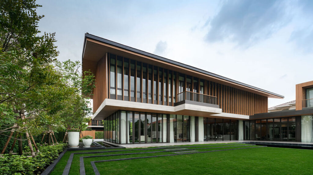 The Santiburi Residences show house, a low modern villa with a wide overhanging roof and a manicured lawn