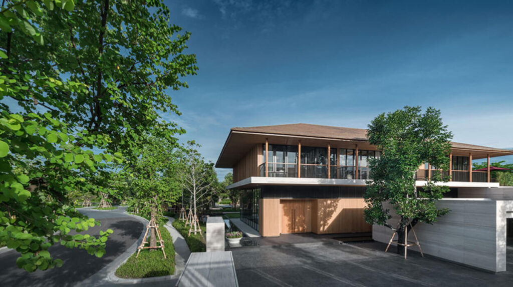 A render of a luxury Bangkok house with a broad timber roof, set among mature trees
