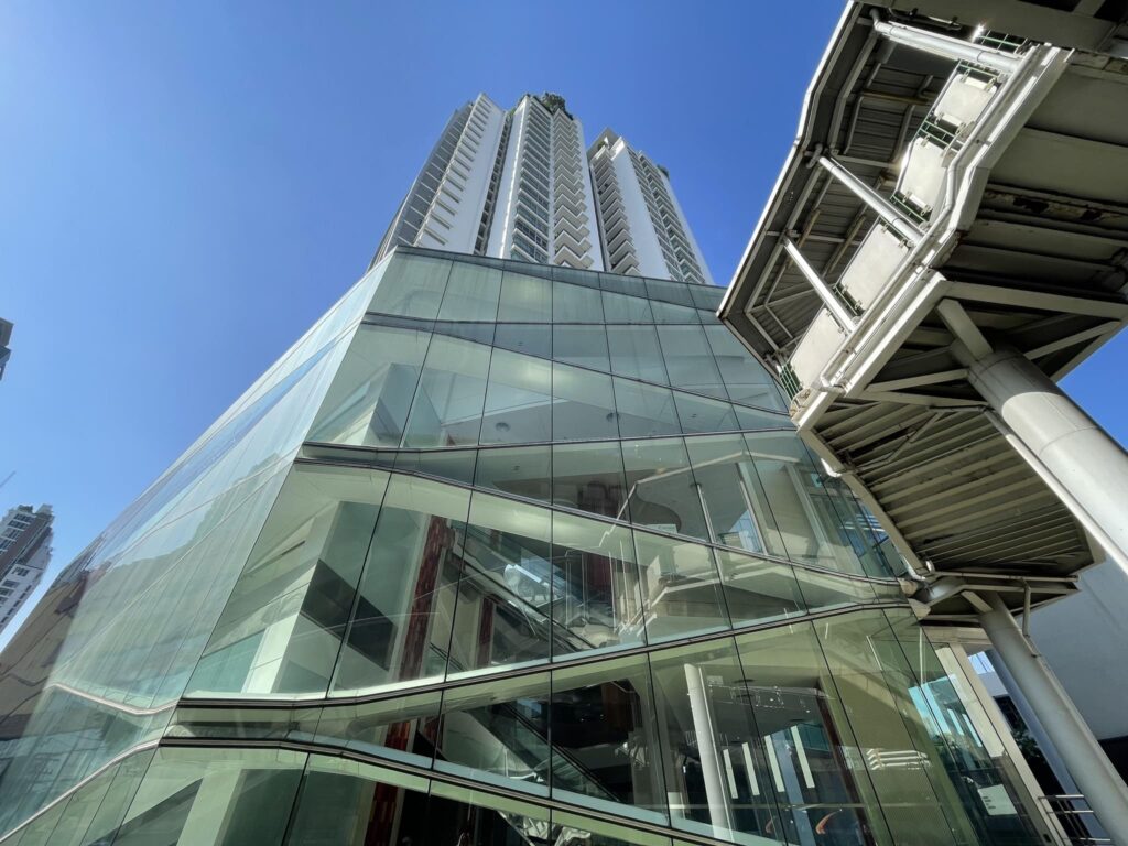 The glass connection linking Nusasiri Grande to the BTS Ekkamai walkway, seen from below