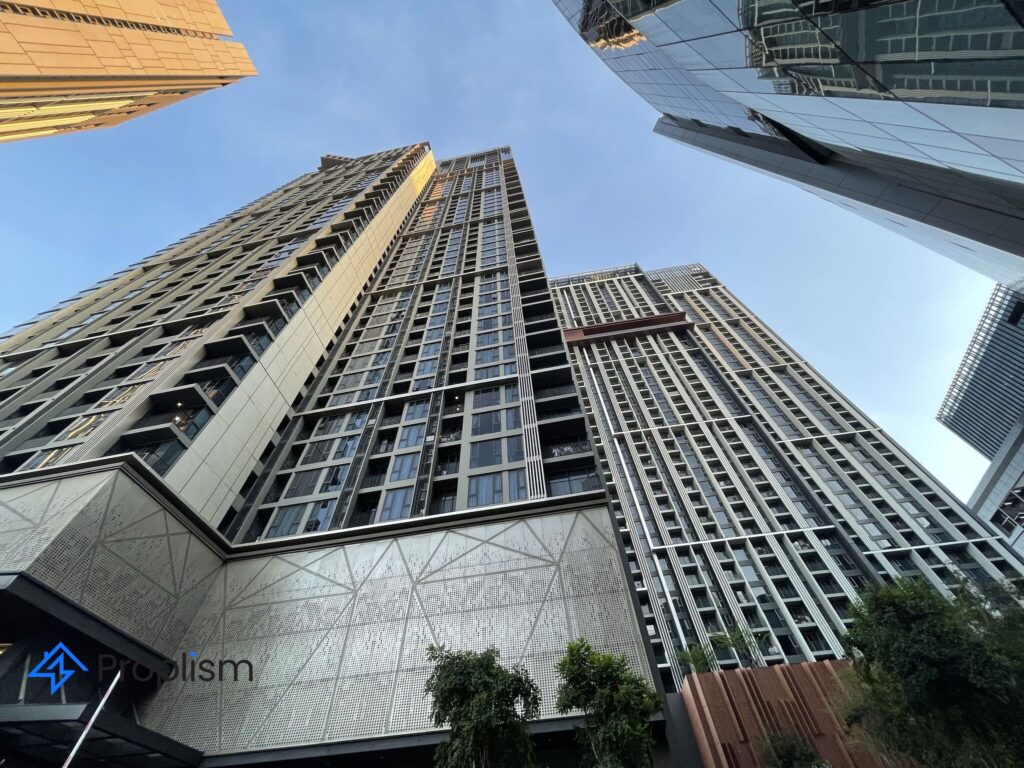 Looking up at the Whizdom Essence towers at BTS Punnawithi from the plaza below