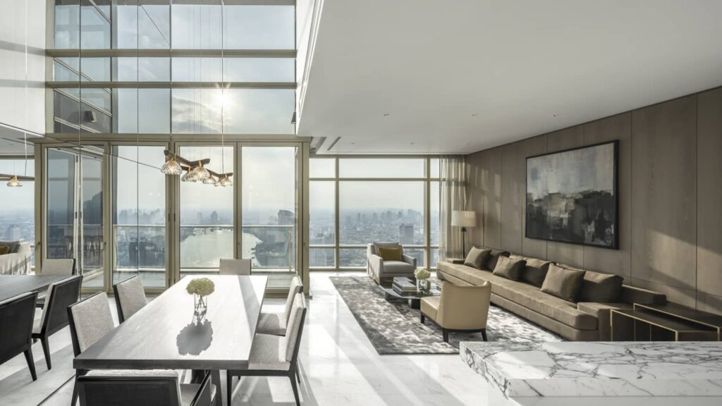 A dining and living room at Four Seasons Private Residences, with floor-to-ceiling river views