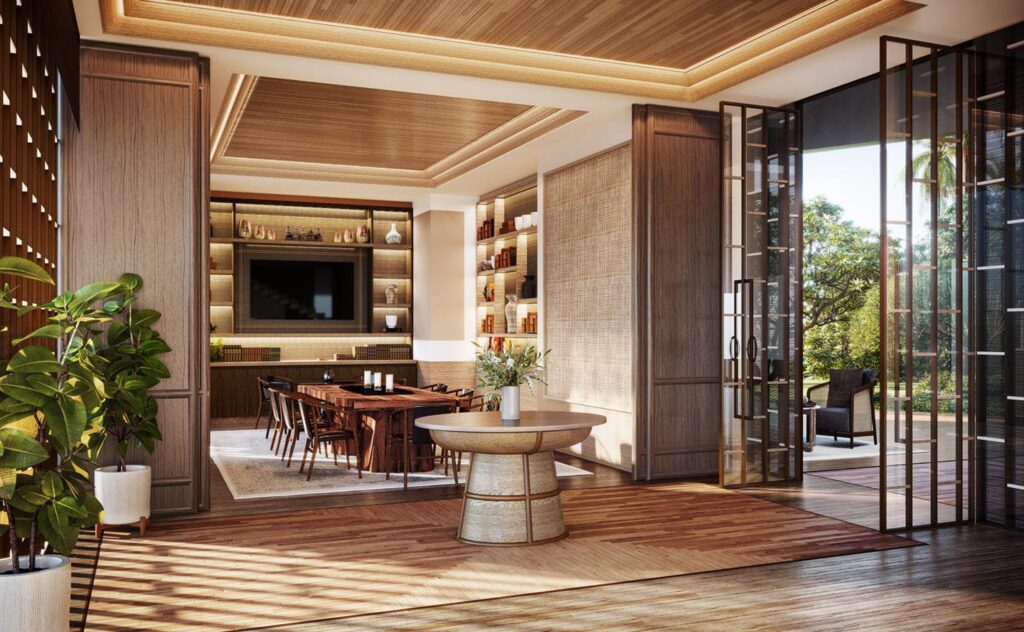 A timber-lined lounge and dining room at Aman Nai Lert, opening onto a planted terrace