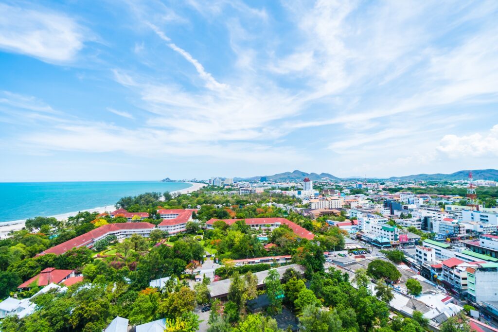 An aerial view over Hua Hin, its green low-rise town meeting the sea