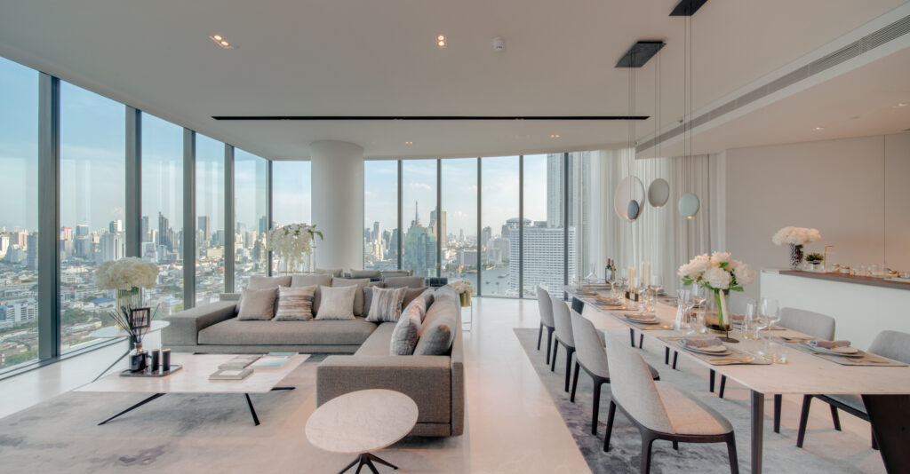 A white living and dining room at Banyan Tree Residences Riverside, with a panoramic city view