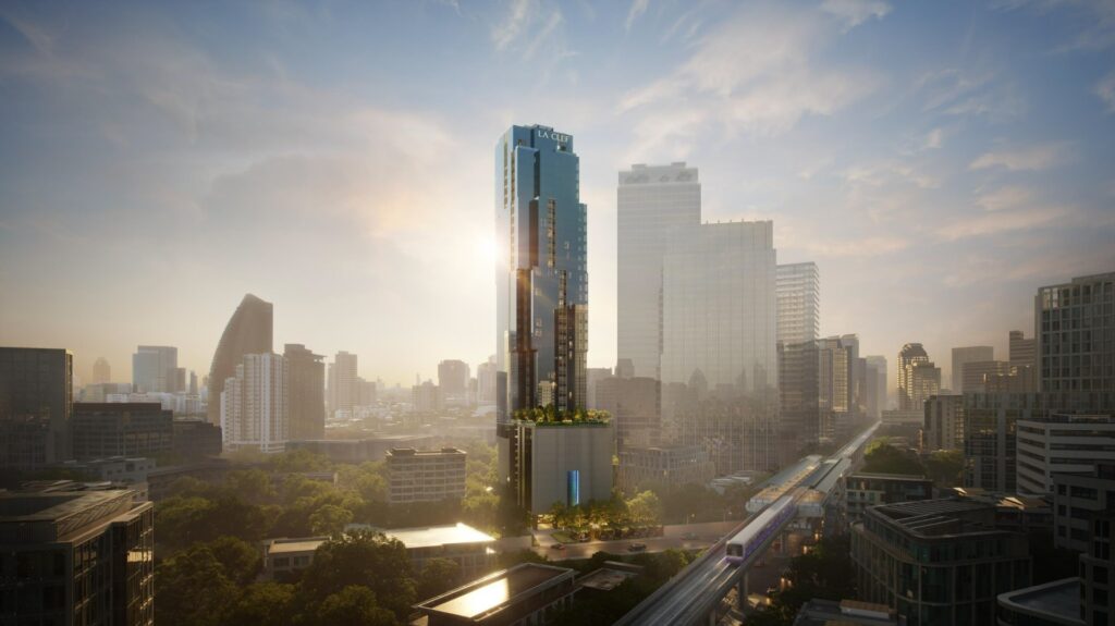 Hazy Bangkok skyline at sunrise, towers backlit by low sun over rooftops