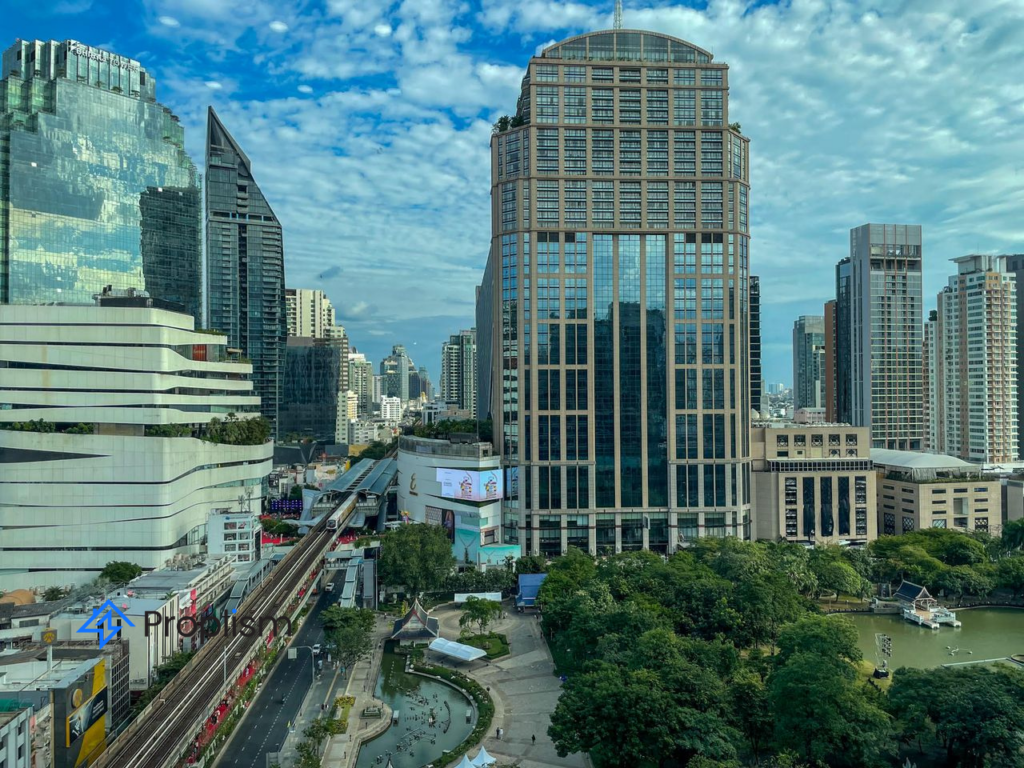 Daytime aerial of Phrom Phong commercial blocks, BTS skytrain line, glass malls and green park