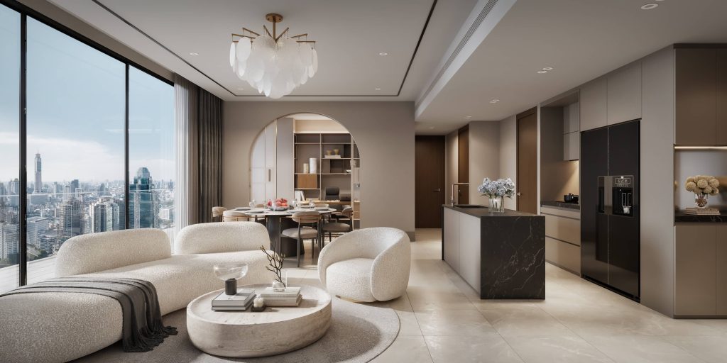 Curved cream sofas and a glass chandelier in a bright condo living room overlooking Bangkok's skyline