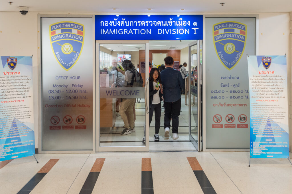 Entrance to Immigration Division 1 in Bangkok, with Royal Thai Police signs and office hours