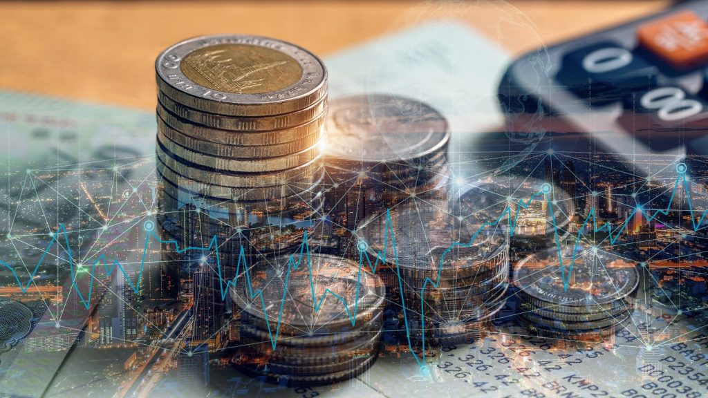 Stacks of Thai baht coins over banknotes and a calculator, overlaid with a glowing financial chart