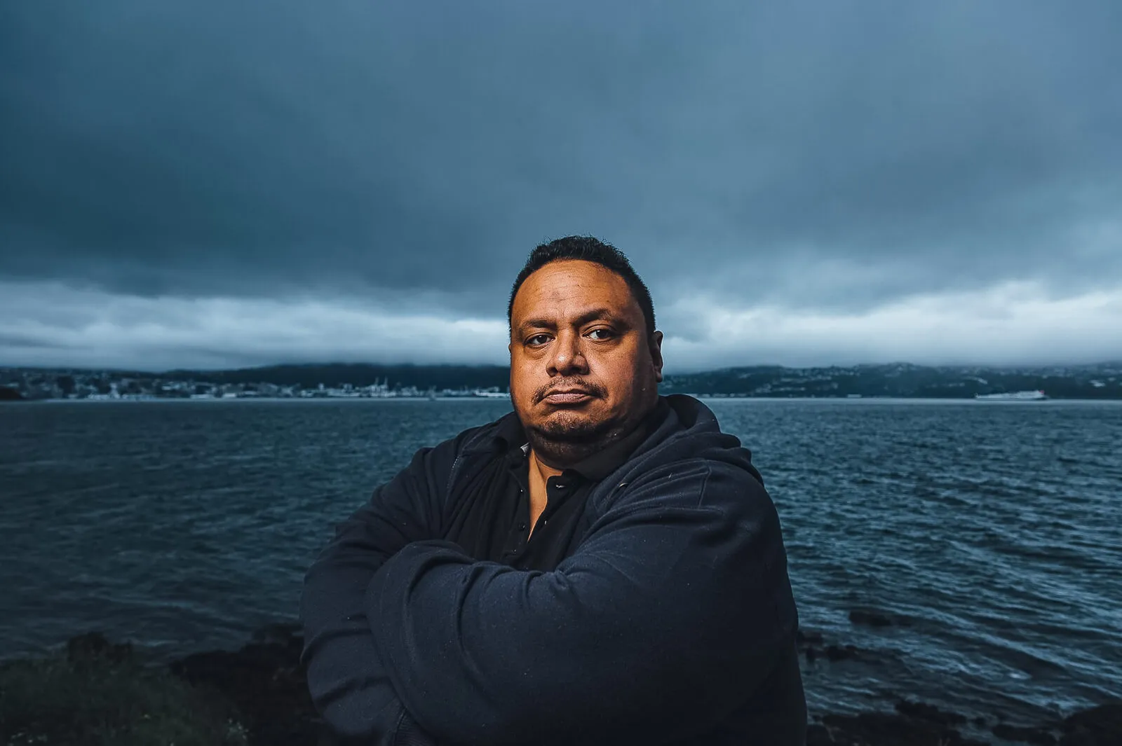 Big Mark standing on the Wellington waterfront beneath a cloudy sky.