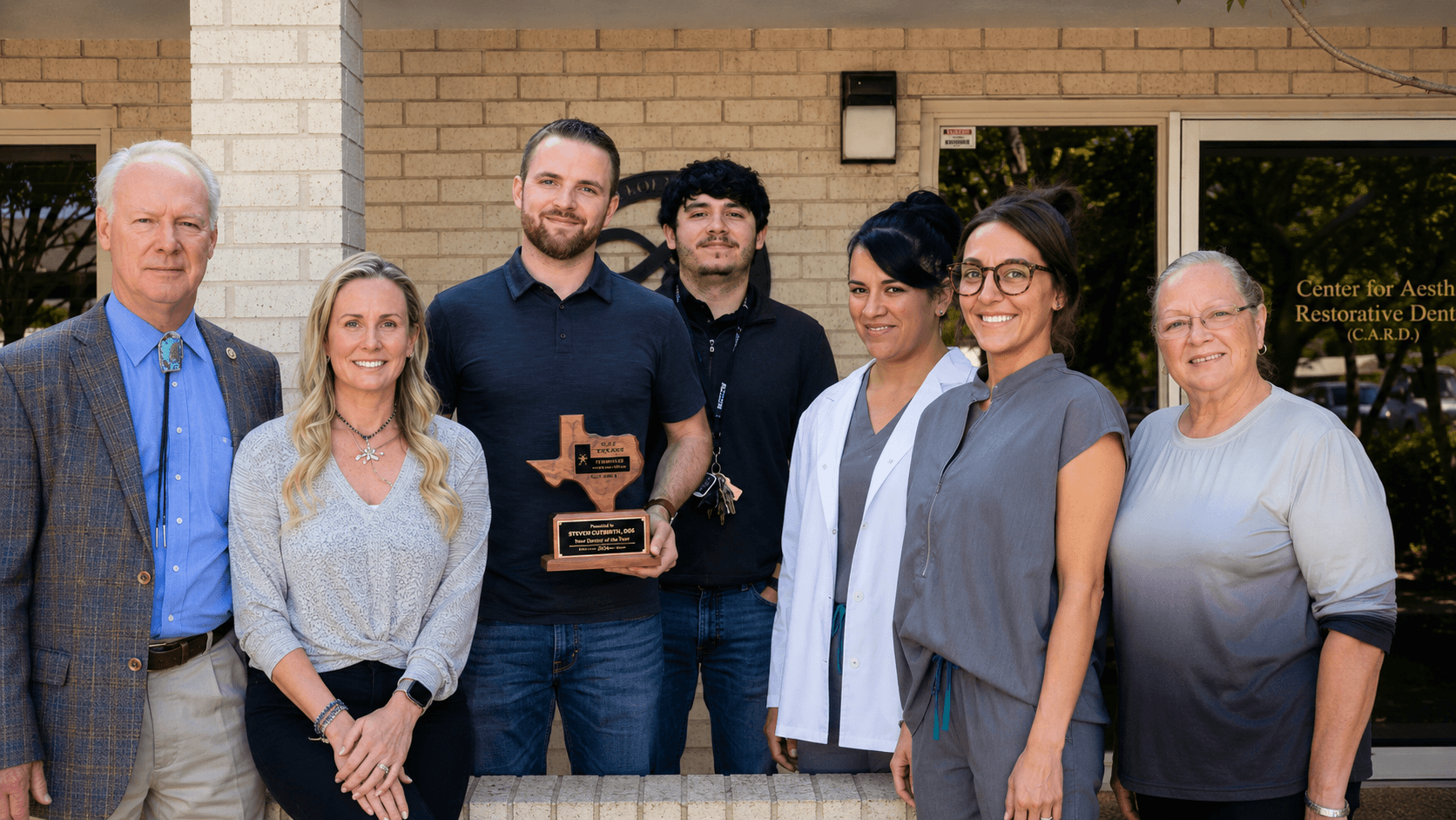 Dr. Steven T. Cutbirth and the dental team standing outside Steven T. Cutbirth DDS in Waco, TX.