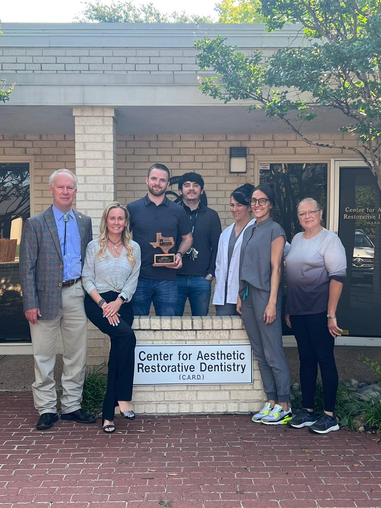 Dr. Steven T. Cutbirth and the dental team standing outside the Steven T. Cutbirth DDS office in Waco, TX.